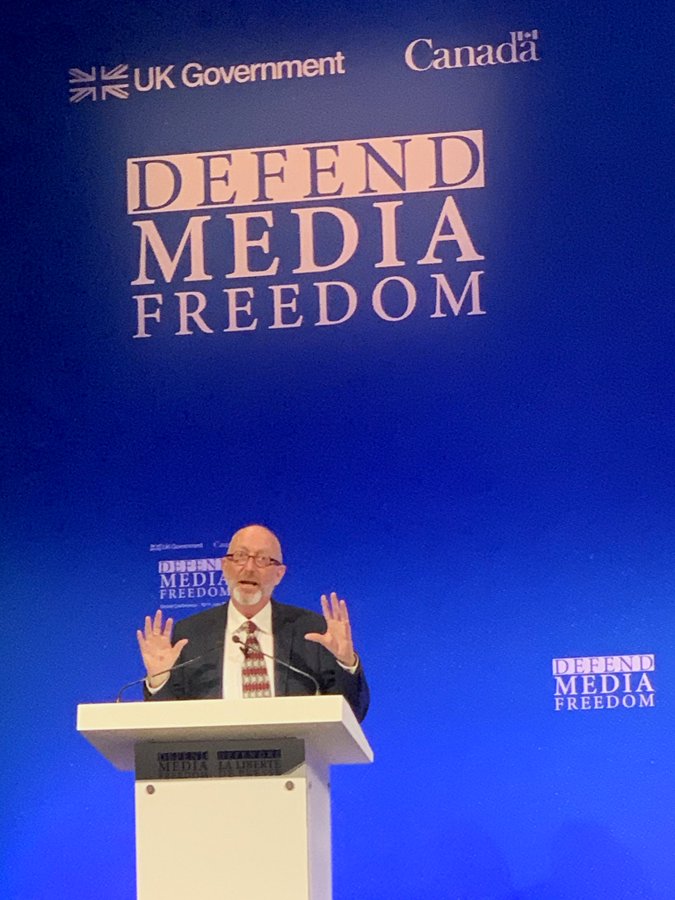 podium closeup of Alan Sunderland Defend Media Freedom
